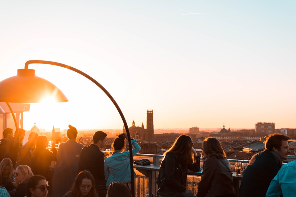 Friends gathered on a rooftop terrace at golden hour