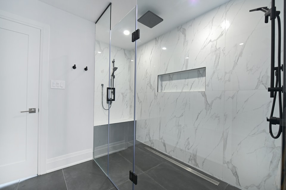A clean, bright bathroom with a walk-in shower — the kind of space a host near an airport could offer